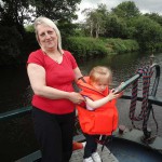 Woman with child steering boat